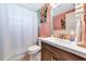 Well-lit bathroom featuring a vanity with storage and a shower with floral wallpaper at 5948 Mirror Lake Rd, Sarasota, FL 34238