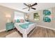 Stylishly decorated bedroom with a comfortable bed, wooden floors, and bright, colorful accents at 5948 Mirror Lake Rd, Sarasota, FL 34238