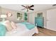 Nicely decorated bedroom with bright accents, wood floors, ceiling fan, and a closet at 5948 Mirror Lake Rd, Sarasota, FL 34238