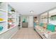 Spacious bedroom with built-in shelves, daybed, and tile floors at 5948 Mirror Lake Rd, Sarasota, FL 34238