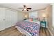 Bedroom featuring a ceiling fan, closet, wood flooring, and bright decor at 5948 Mirror Lake Rd, Sarasota, FL 34238
