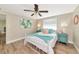 Well-lit bedroom with wood flooring, a comfortable bed, and modern decor at 5948 Mirror Lake Rd, Sarasota, FL 34238
