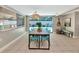 Bright dining room with a large table, view of the pool, and stylish decor with plenty of natural light at 5948 Mirror Lake Rd, Sarasota, FL 34238