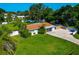 Aerial view of a well-manicured lawn and landscaping, privacy fence and screened in back porch at 5948 Mirror Lake Rd, Sarasota, FL 34238