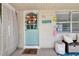 Cozy front porch with charming decor, a bench, a decorative door, and marine themed decorations at 5948 Mirror Lake Rd, Sarasota, FL 34238