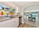 Charming kitchen featuring stainless steel appliances and a view of the dining area and pool at 5948 Mirror Lake Rd, Sarasota, FL 34238