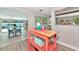 Transition view into the dining room, which offers a view of the pool with plenty of natural light at 5948 Mirror Lake Rd, Sarasota, FL 34238
