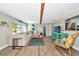 Bright living room with a large sectional sofa, TV, and wood floors at 5948 Mirror Lake Rd, Sarasota, FL 34238