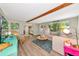 Cozy living room with wood beam, stylish decor, and comfortable seating arrangement bathed in natural light at 5948 Mirror Lake Rd, Sarasota, FL 34238