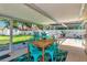 Outdoor patio featuring dining and lounge seating with a view of the pool and lush backyard at 5948 Mirror Lake Rd, Sarasota, FL 34238
