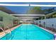 In-ground screened pool area with plenty of space, lounge chairs, and a well-maintained deck at 5948 Mirror Lake Rd, Sarasota, FL 34238