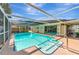 Inviting screened in-ground pool area with lounge chairs and a well-maintained deck offering relaxing space at 5948 Mirror Lake Rd, Sarasota, FL 34238