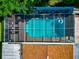 Overhead aerial image of a screened-in pool area with lounge chairs and white inflatable at 5948 Mirror Lake Rd, Sarasota, FL 34238