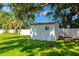 Lawn and garden shed in a large backyard with privacy fence at 5948 Mirror Lake Rd, Sarasota, FL 34238