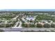 Expansive aerial view of the community showcases lush trees, a serene lake, and well-maintained streets at 6043 44Th E Ct, Bradenton, FL 34203