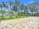 Scenic backyard features a paved patio, lush grass and mature trees at 6043 44Th E Ct, Bradenton, FL 34203