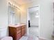 Bathroom with tile flooring, vanity with a sink, and an open doorway to a bedroom at 6043 44Th E Ct, Bradenton, FL 34203