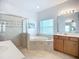 Bright bathroom showcasing a glass-enclosed shower and a separate soaking tub at 6043 44Th E Ct, Bradenton, FL 34203