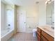 Bathroom featuring a bathtub with shower, tile flooring, and wood vanity at 6043 44Th E Ct, Bradenton, FL 34203