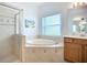Bathroom featuring a soaking tub and a glass shower with tile surround at 6043 44Th E Ct, Bradenton, FL 34203