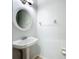 Powder room features a pedestal sink with an oval mirror and a charming light fixture at 6043 44Th E Ct, Bradenton, FL 34203