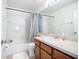Well-lit bathroom featuring a bathtub with shower, single sink vanity, and tile flooring at 6043 44Th E Ct, Bradenton, FL 34203