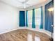 Cozy bedroom featuring hardwood floors, natural light and blue drapes at 6043 44Th E Ct, Bradenton, FL 34203