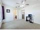 Spacious bedroom featuring neutral carpet, a ceiling fan, and ensuite bathroom at 6043 44Th E Ct, Bradenton, FL 34203