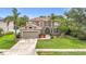 Charming two-story home with a manicured lawn, mature trees, and a two-car garage at 6043 44Th E Ct, Bradenton, FL 34203