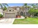Attractive exterior view of a two-story home featuring a well-kept lawn and landscaping at 6043 44Th E Ct, Bradenton, FL 34203
