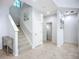 Bright foyer features tiled flooring, stairs with carpet, and white trim at 6043 44Th E Ct, Bradenton, FL 34203