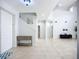 Bright and open foyer with neutral tile floors, a staircase, and high ceilings at 6043 44Th E Ct, Bradenton, FL 34203