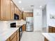 Well-lit kitchen with wood cabinets, stainless steel appliances, and elegant marble countertops at 6043 44Th E Ct, Bradenton, FL 34203
