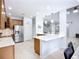 Bright, open kitchen with stainless steel appliances, marble countertops and island with pendant lights at 6043 44Th E Ct, Bradenton, FL 34203