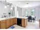 Kitchen features island with breakfast bar, dining area, and lots of natural light at 6043 44Th E Ct, Bradenton, FL 34203
