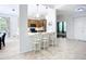 Open-concept kitchen featuring a breakfast bar with seating and views of the dining and living areas at 6043 44Th E Ct, Bradenton, FL 34203