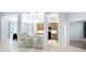 Open-concept kitchen featuring breakfast bar and modern light fixtures at 6043 44Th E Ct, Bradenton, FL 34203