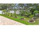 Landscaped backyard featuring a brick patio and landscaped garden beds at 6043 44Th E Ct, Bradenton, FL 34203
