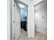 Laundry room featuring a doorway to a half bathroom, tile floors, and stacked appliances at 6043 44Th E Ct, Bradenton, FL 34203