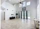 Bright living room features soaring ceilings, large windows, and tiled flooring at 6043 44Th E Ct, Bradenton, FL 34203