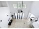 Open concept room offers tile flooring, a ceiling fan, and bright windows with curtains at 6043 44Th E Ct, Bradenton, FL 34203