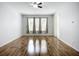 Bright living room featuring wood floors, neutral walls, and natural light from the large windows at 6043 44Th E Ct, Bradenton, FL 34203