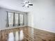 Spacious living area with wood flooring, neutral paint, ceiling fan, and sliding glass door at 6043 44Th E Ct, Bradenton, FL 34203