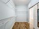 Spacious walk-in closet featuring wooden floors and wire shelving for ample storage at 6043 44Th E Ct, Bradenton, FL 34203