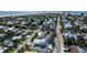 An aerial view of a beach neighborhood showcasing a modern home with a pool within walking distance to the beach at 616 Fern St, Anna Maria, FL 34216