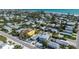 Beautiful aerial view of a coastal home with a pool, set amongst lush landscaping and close to the beach at 616 Fern St, Anna Maria, FL 34216