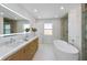 Stunning bathroom features a dual sink vanity, a soaking tub and a glass enclosed shower at 616 Fern St, Anna Maria, FL 34216