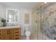 Modern bathroom featuring an eye-catching vanity and a glass enclosed shower with herringbone tile at 616 Fern St, Anna Maria, FL 34216
