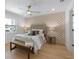 Charming bedroom boasts modern decor, wood floors, and unique accent wall at 616 Fern St, Anna Maria, FL 34216