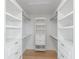 Walk-in closet with custom shelving, built-in drawers, and plenty of storage space at 616 Fern St, Anna Maria, FL 34216
